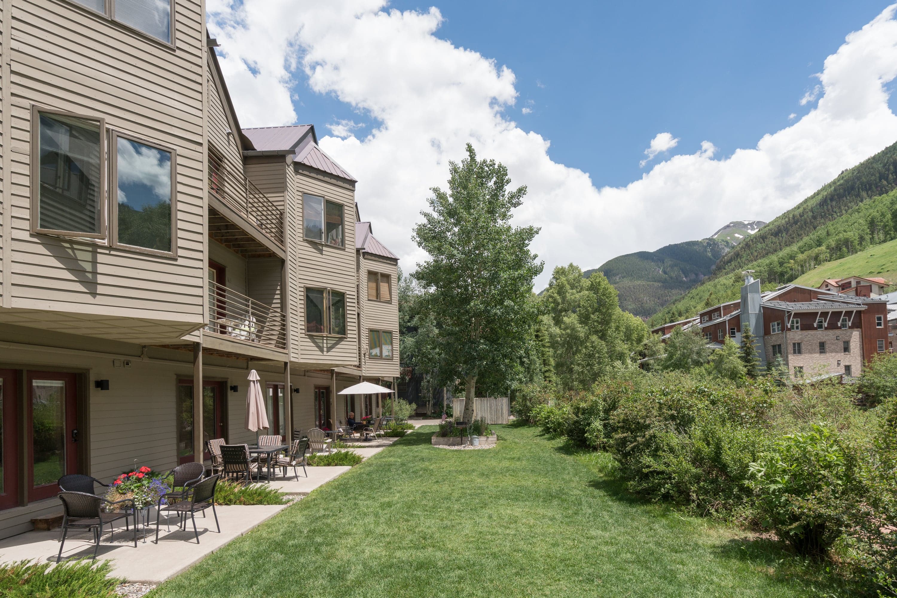 Exterior view of the back patio at a River Song condo. The mighty San Miguel River is right to the right of this photo