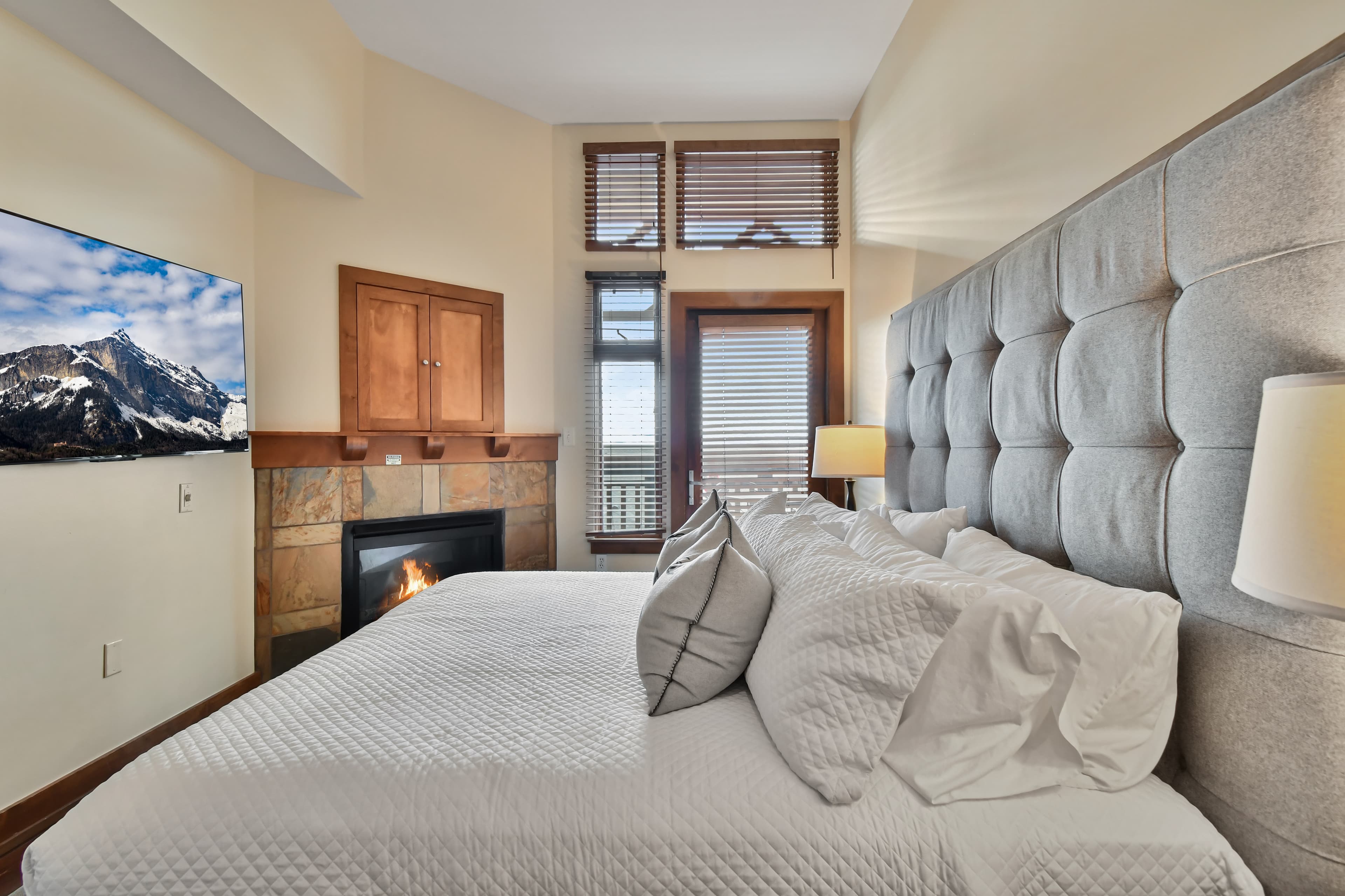 Primary bedroom with king bed and fireplace