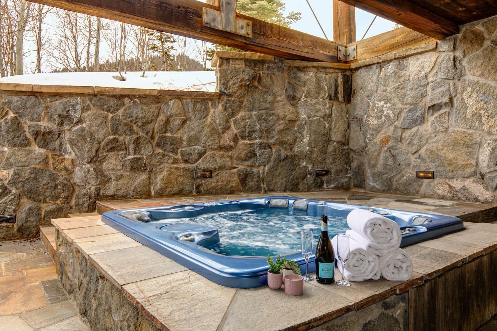 The private hot tub of Talus Ridge, surrounded by rock walls and sitting in the center of the space.