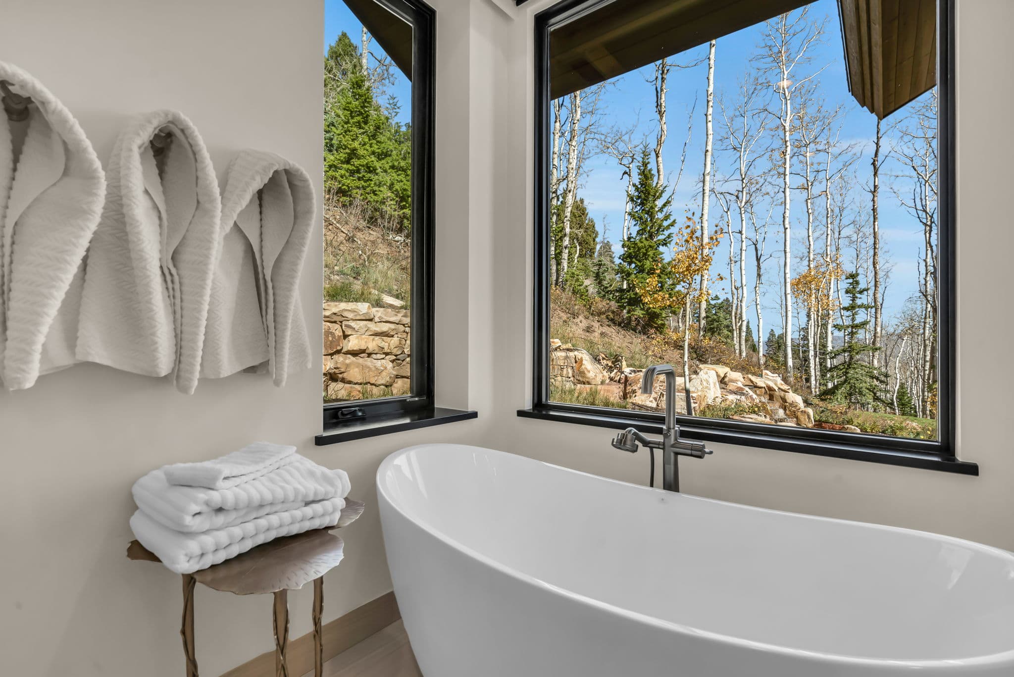 Bathtub Next to a Window with a View of the Mountains
