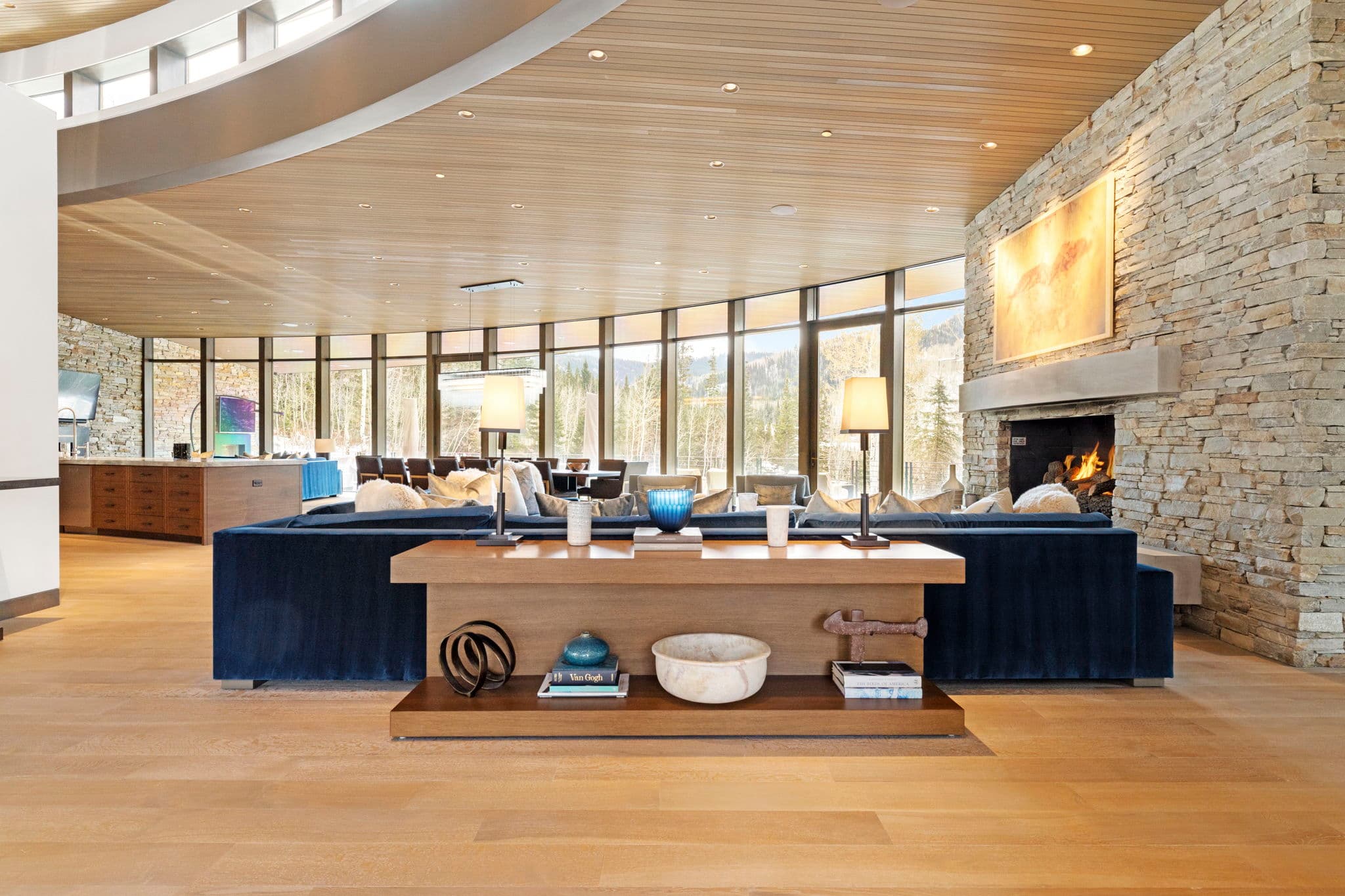 A living area view with a blue sofa and table with decor.
