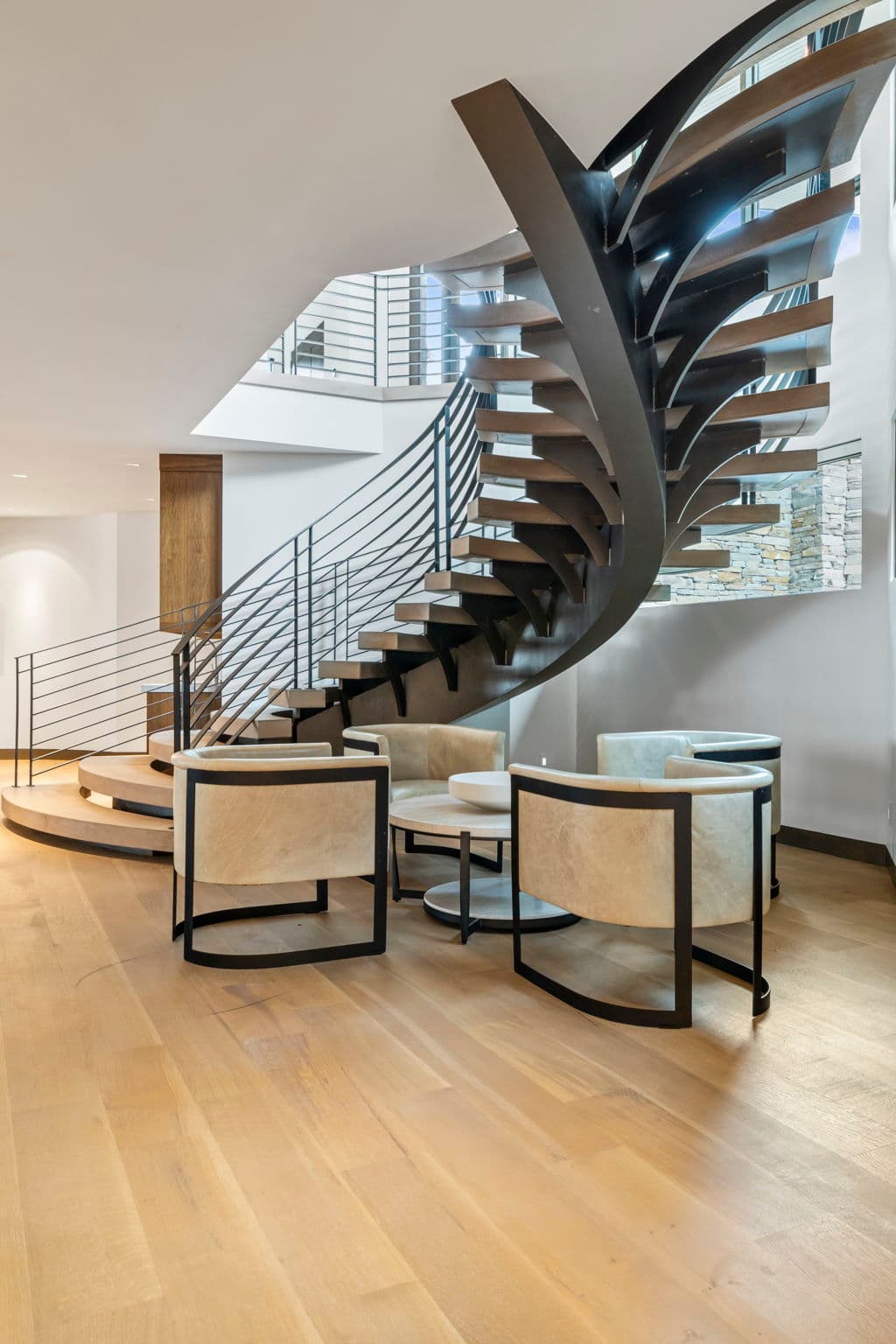 A view of a staircase and seating area for four.