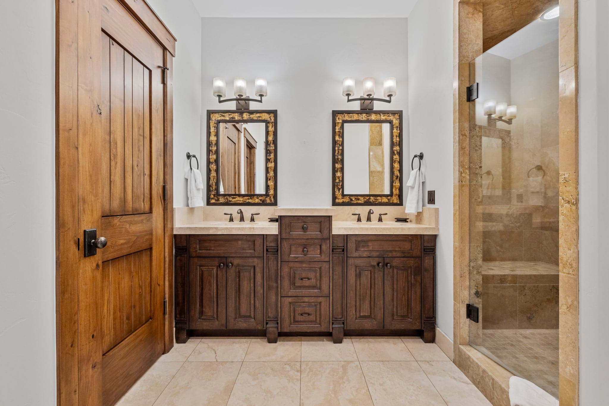guest bathroom with dual vanities and luxurious cabinetry